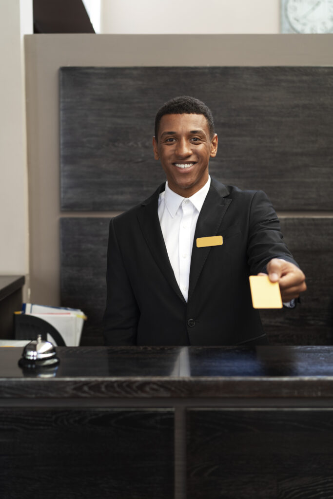 male receptionist suit offering room key male receptionist suit offering room key